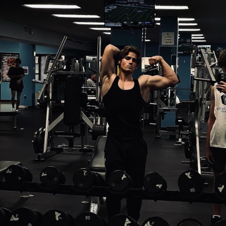 Brady Hepner flexes his muscles during a workout session.